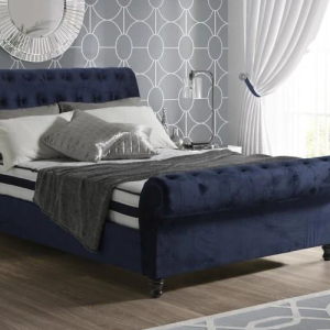 Royal blue sleigh bed featuring a curved design and soft upholstery.